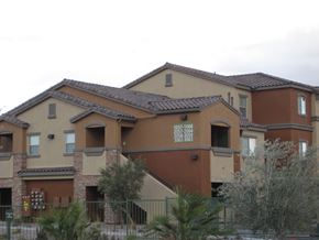 Las Vegas apartment for rent - A brown building with a fence in front of it.