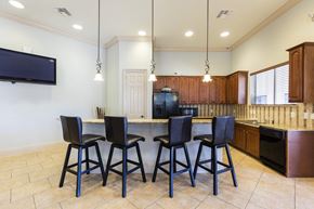 Kissimmee apartment for rent - Rapallo Apartments community clubhouse kitchen area equipped with refrigerator, microwave, and dishwasher.