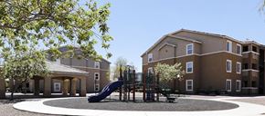 North Las Vegas apartment for rent - A playground with a slide in front of a building.