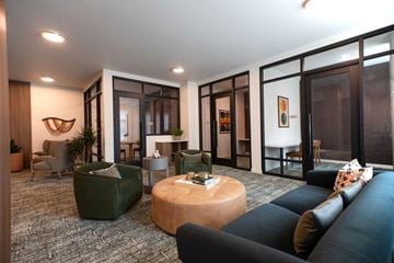 Tigard apartment for rent - A living room with a green couch and a wooden coffee table.
