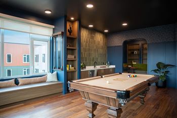 Billiards room with pool table and wet bar
