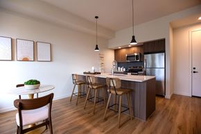 Tigard apartment for rent - Open concept kitchen with island seating and dining area at Montage Apartments, Tigard