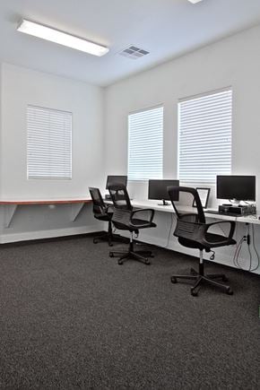 North Las Vegas apartment for rent - an office with three desks with chairs and a computer