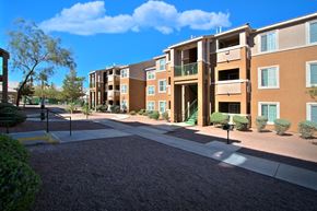 North Las Vegas apartment for rent - an exterior view of an apartment building with a sidewalk and courtyard