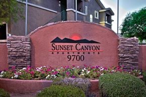 Las Vegas apartment for rent - a sign for sunset canyon apartments in front of flowers