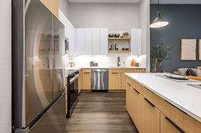 Kissimmee apartment for rent - A modern kitchen with wooden cabinets and a white countertop.at Parkway Crossings, Kissimmee, FL 34744