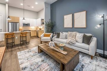 Kissimmee apartment for rent - A modern living room with a grey couch and a wooden coffee table.