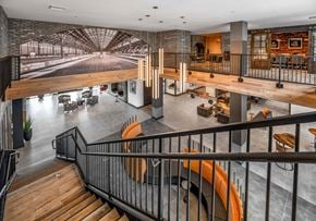 Kissimmee apartment for rent - A modern interior with a staircase and a large mural on the wall at Parkway Crossings Apartments, Kissimmee