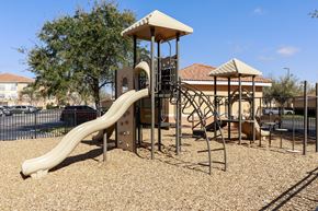 Kissimmee apartment for rent - Rapallo Apartments community playground equipped with slide and jungle gym.