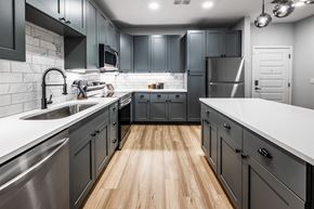 Ocoee apartment for rent - Kitchen with gray cabinets at The Alibi at Lake Lilly, Ocoee, 34761