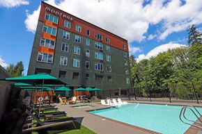 Tigard apartment for rent - Outdoor pool with lounge chairs and umbrellas at Montage Apartments, Tigard