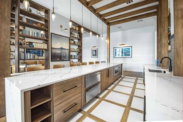Kissimmee apartment for rent - A modern kitchen with wooden cabinets and a white countertop.
