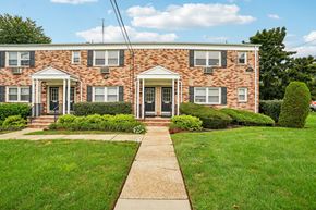 West Caldwell apartment for rent - A brick house with a green lawn in front.