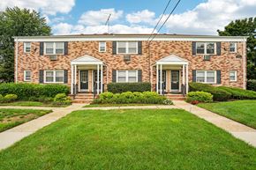 West Caldwell apartment for rent - A brick house with a green lawn in front.