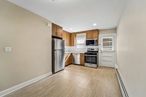 South River apartment for rent - A kitchen with a refrigerator, oven, and microwave.
