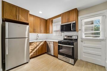South River apartment for rent - A kitchen with wooden cabinets and stainless steel appliances.
