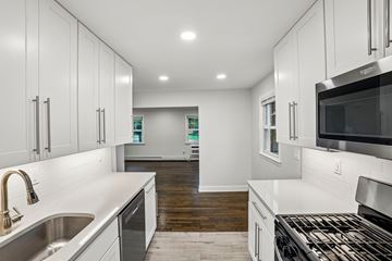 West Caldwell apartment for rent - A modern kitchen with white cabinets and stainless steel appliances.