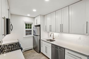 West Caldwell apartment for rent - A kitchen with white cabinets and a stainless steel refrigerator.