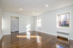 Bayonne apartment for rent - A room with wooden floors and white walls.