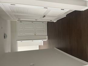 Wayne apartment for rent - A white door with a white frame is in a room with a brown wall.