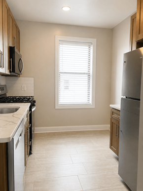 Bayonne apartment for rent - A kitchen with a stove, sink, and refrigerator.