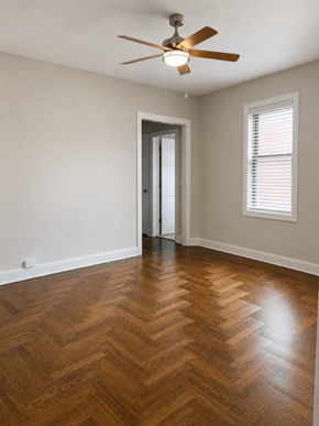 Bayonne apartment for rent - A room with a wooden floor and a ceiling fan.