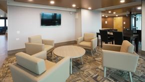 Denver apartment for rent - A living room with a couch, chairs, and a television at Denver Metro Village Apartments, Colorado, 80204
