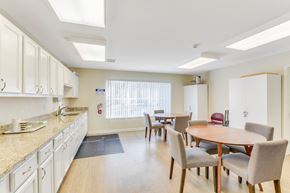 Middle Island apartment for rent - A kitchen with a table and chairs in the middle of the room.