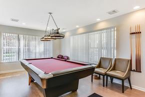 Middle Island apartment for rent - A pool table with a red cloth and a light hanging above it.