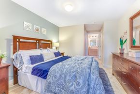 Federal Way apartment for rent - A bedroom with a bed, dresser, and mirror at The Lodge at Peasley Canyon in Federal Way, 98001