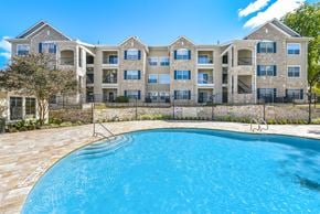 Austin apartment for rent - A large apartment complex with a swimming pool in front at Acclaim at South Congress, Austin, 78704
