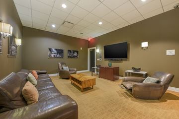 Washington apartment for rent - A living room with brown leather furniture and a flat screen TV mounted on the wall.