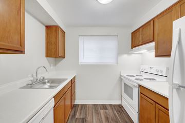 Maple Valley apartment for rent - A kitchen with wooden cabinets and white appliances.