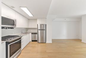 Brooklyn apartment for rent - A kitchen with white cabinets and stainless steel appliances.