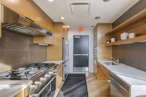 Washington apartment for rent - A modern kitchen with a stove top oven and a sink. at Affinity at 2M, Washington, 20002