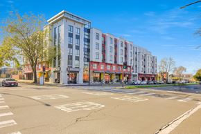 Berkeley apartment for rent - A street view of a multi-story building with a car parked in front. at Acton Courtyard, Berkeley, California