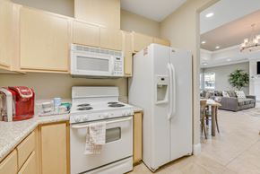 Antelope apartment for rent - Kitchen with white appliances and wood cabinets at Sierra Creek Apartments, California