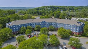 Wharton apartment for rent - Aerial view of blue apartment building with parking at Centennial Court Apartments, Wharton, 7885