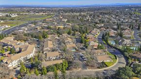 Roseville apartment for rent - Expansive aerial view of residential buildings and landscaping at Woodcreek Terrace Apartments, Roseville, California