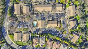 Roseville apartment for rent - Aerial view of parking areas and residential buildings at Woodcreek Terrace Apartments, California, 95747