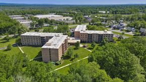 Edison apartment for rent - A large building complex surrounded by trees at Menlo Manor Apartments, Edison, NJ, 08820