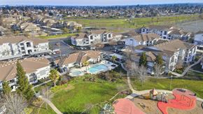 Elk Grove apartment for rent - A bird's eye view of a residential area with a swimming pool and playground.