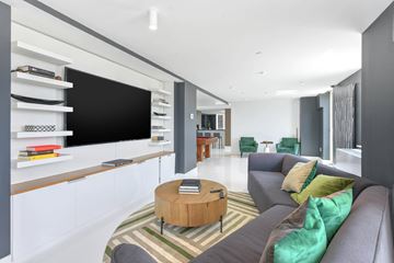 Brooklyn apartment for rent - A modern living room with a grey couch and a wooden coffee table.