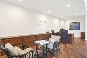 Novato apartment for rent - A living room with a table and chairs and a painting on the wall.