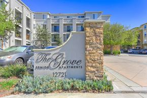 Garden Grove apartment for rent - The Grove Senior Apartments is a building with a stone pillar and a sign in front of it.