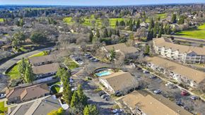Roseville apartment for rent - Aerial view of community pool and parking areas at Woodcreek Terrace Apartments, California, 95747