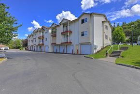 Kent apartment for rent - Apartment building with a parking lot in front. at Silver Springs, Kent, WA, 98031