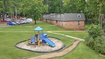 Cary apartment for rent - A playground with a blue slide and a green roof.