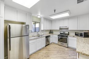 Pasadena apartment for rent - A kitchen with white cabinets and stainless steel appliances.