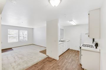 Elk Grove apartment for rent - A kitchen with white cabinets and a white stove top oven.